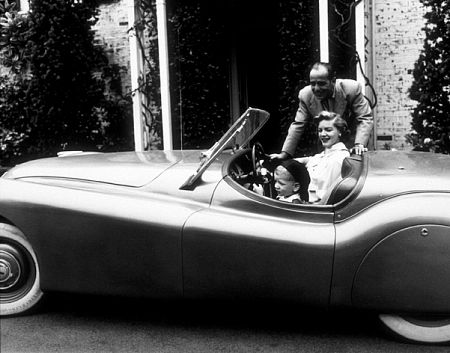 Humphrey Bogart, Lauren Bacall, and their son, Stephen, in his Jaguar XK120 at home in Los Angeles, CA, 1952.