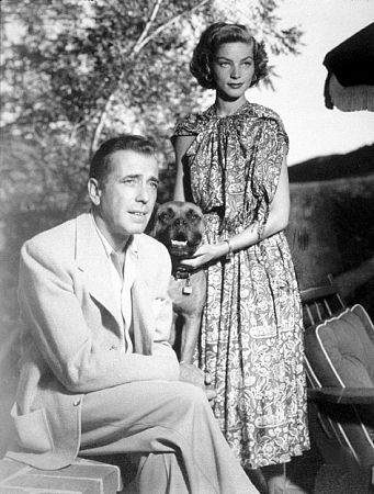 Humphrey Bogart and Lauren Bacall with their pet boxer, circa 1949.