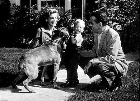 Humphrey Bogart, Lauren Bacall, and their son, Stephen, with their boxer, Harvey, at home, circa 1951.