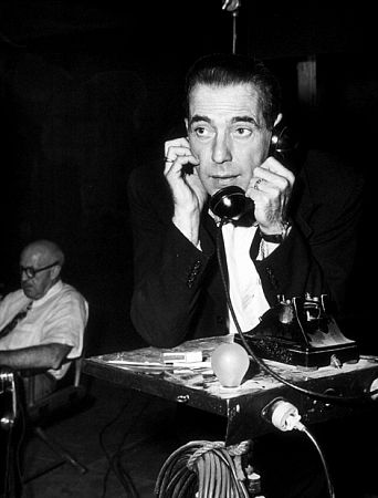 Humphrey Bogart phoning home during a break from filming 