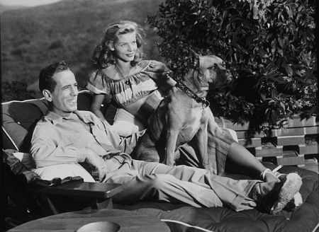 Humphrey Bogart and Lauren Bacall with their pet boxer, Harvey, at their Benedict Canyon home, CA, 1948.