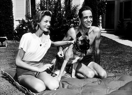 Humphrey Bogart and Lauren Bacall with their pet boxer at their Benedict Canyon home, CA, 1947.