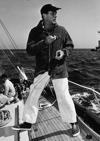 Humphrey Bogart standing on his racing yacht, 