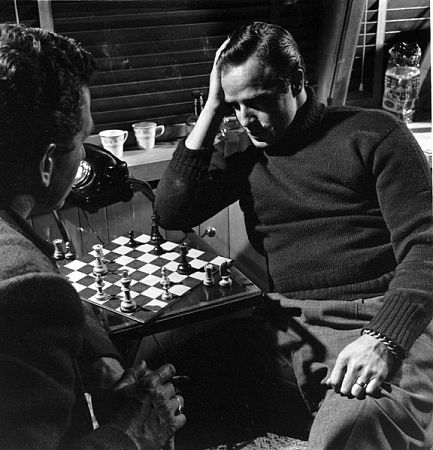 Marlon Brando playing chess in the den of his Beverly Glen home in Los Angeles