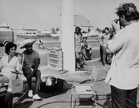 Elizabeth Taylor and a friend get photographed by Richard Burton