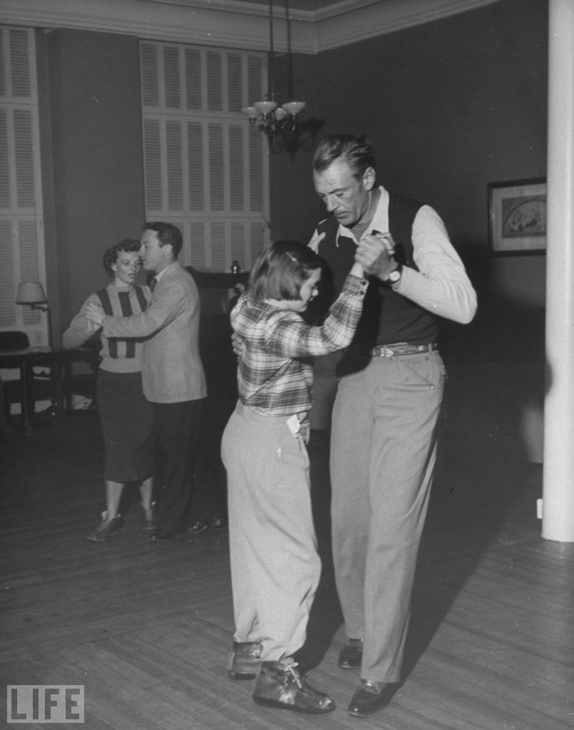 Gary Cooper shows his daughter Maria a few dance steps during a ski vacation in 1949.