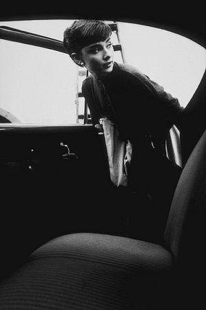 Audrey Hepburn getting into her car after a photo session at Paramount, 1953.