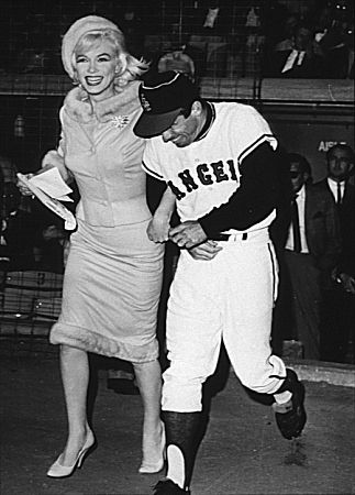 M. Monroe & Angles outfielder Albie Pearson run onto the field at Chavez Ravine. June 1, 1962