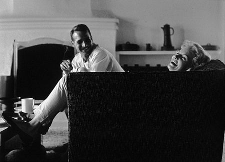 Paul Newman and Joanne Woodward at home sitting on their couch, 1958. Modern silver gelatin, 11x14, signed. © 1978 Sid Avery MPTV