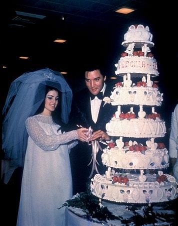 Elvis Presley and his bride, the former Priscilla Ann Beaulieu, cutting their wedding cake in Las Vegas, 5/26/67.