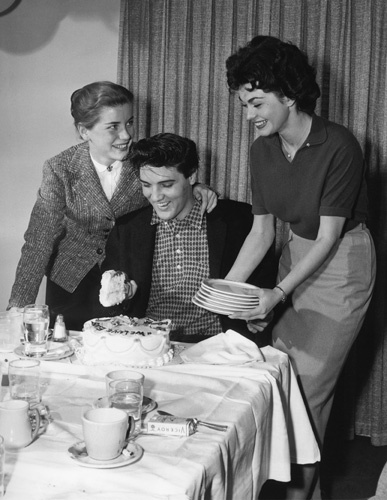 Elvis Presley with Dolores Hart and Valerie Allen at an Army Bond farewell party given by Hal Wallis during the making of 