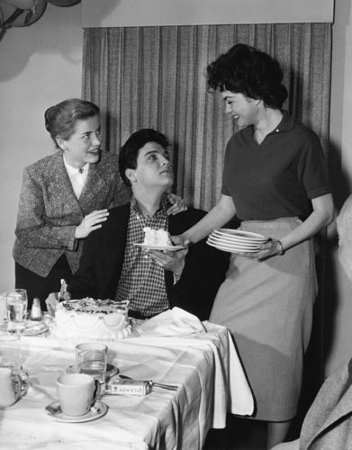 Elvis Presley with Dolores Hart and Valerie Allen at an Army Bond farewell party given by Hal Wallis during the making of 