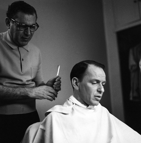 Frank Sinatra gettting a haircut circa 1960