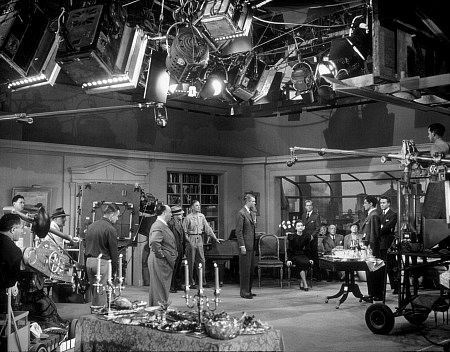 James Stewart, Alfred Hitchcock, and Cast on the set of 