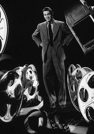 James Stewart standing between large film reels, 1936. Modern silver gelatin, 14x11, estate stamped. $600 Modern silver gelatin, 20x16, estate stamped. $800 © 1978 Ted Allan MPTV