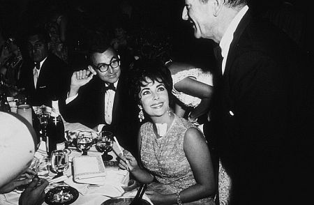 Elizabeth Taylor, John Wayne and Danny Thomas at a party thrown by Eddie Fisher at the Coconut Grove C. 1960