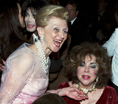 Elizabeth Taylor and Barbara Davis admire each others jewelry at the Carousel of Hope awards dinner at the Beverly Hilton Hotel (Michael Jackson in background)