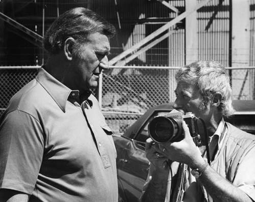 John Wayne and photographer David Sutton on the set of 