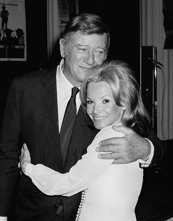 John Wayne with his wife Pilar at a party for Henry Hathaway, C. 1972