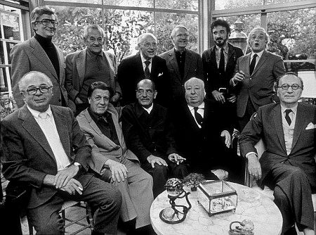 Directors Group, Nov. 1972. George Cukor Hosts a party for Luis Bunuel. Back Row from left: Robert Mulligan, William Wyler, George Cukor, Robert Wise, Jean-Claude Carriere, and Serge Silverman. Front Row from left: Billy Wilder, George Stevens, Luis Bunuel, Alfred Hitchcock, and Rouben Mamoulin.