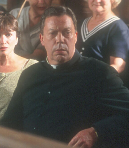 Tim Curry as Father Antoine