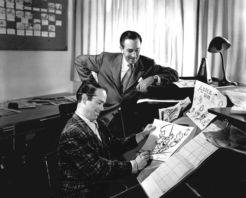Walt Disney with Ward Kimball working on the animation and character design for 