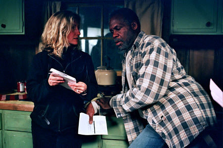 Director Gabrielle Savage Dockterman discusses a scene with Danny Glover on the set of WOODCUTTER.