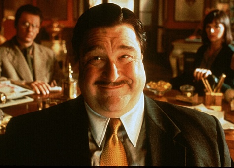 John Goodman stars as the evil local lawyer, Ocious P. Potter in 