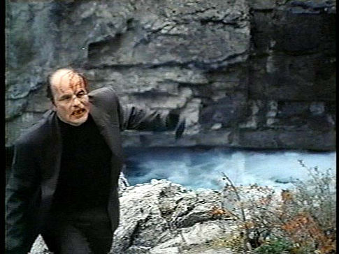 Luther (Michael Ironside) rages against Max at the cliff's edge. David Winning's KILLER IMAGE (1992)