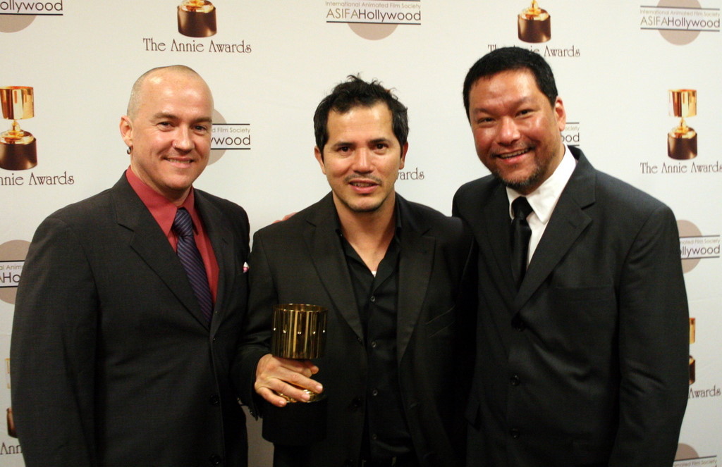 Presenter John Leguizamo surrounded by storyboard winners Tom Owens and Robert Koo