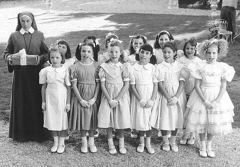 Respendent in their party dresses, Madeline (Hatty Jones, front row, far left) and her classmates attend Pepito's birthday party with the help of gift-toting Miss Clavel (Frances McDormand, far left).