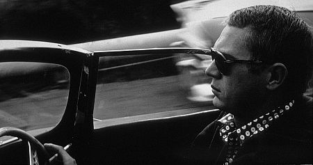 Steve McQueen driving his Jaguar XK-SS through Bell Canyon in Hollywood, 1960. Modern silver gelatin, 11x14, signed. Modern silver gelatin, 16x20, signed. © 1978 Sid Avery MPTV