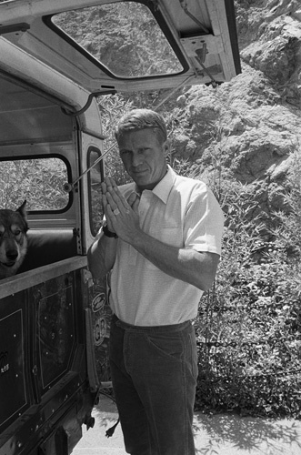 Steve McQueen at home on Solar Drive in the Hollywood Hills with his dog and Land Rover circa 1963