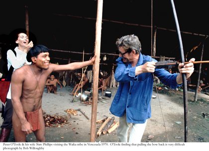 Peter O'Toole and his wife Sian Phillips visiting the Waika tribe in Venezuela. O'Toole finding that pulling the bow back is very difficult 1970 © 1978 Bob Willoughby