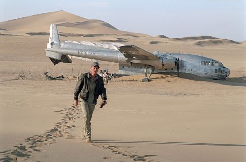With his downed plane looming ominously in the background, Towns (Dennis Quaid) searches for a missing passenger.