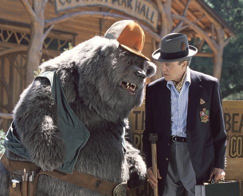 Big Al (left), longtime caretaker of Country Bear Hall, gives the lowdown to Reed Thimple (Christopher Walken, right), an evil banker determined to destroy the legendary venue.