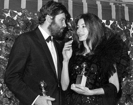Anouk Aimee with husband Pierre Barouh holding her Golden Globe Award at the Cocoanut Groove, 1967.