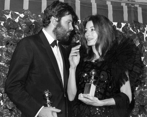 Anouk Aimee with husband Pierre Baruch holding her Golden Globe Award at the Cocoanut Groove, 1967.