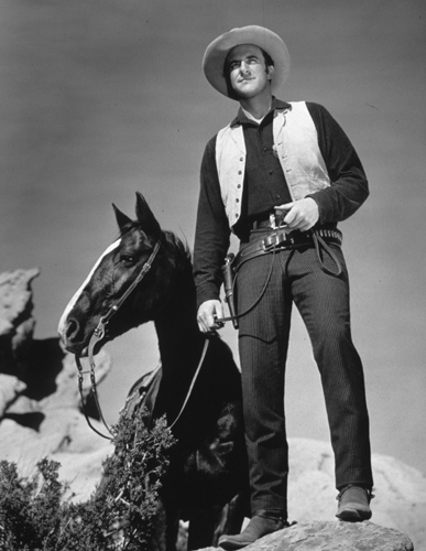 James Arness standing next to a horse, circa 1956.