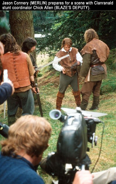 Jason Connery (MERLIN) prepares to do battle after an ambush by the forest people. MERLIN: The Magic Begins (1998).