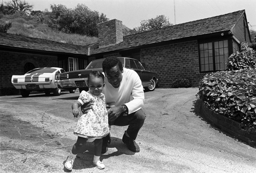 Bill Cosby at home with his daughter Erika (1966 Ford Shelby GT350 Mustang in background)