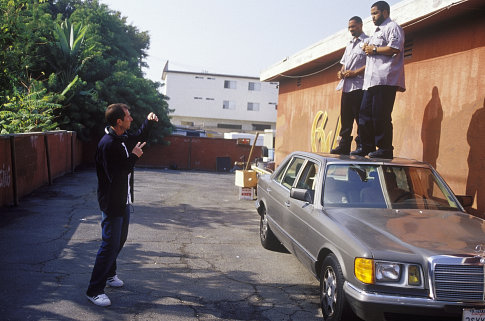 (left to right) Director Marcus Raboy instructs stars Mike Epps and Ice Cube how he wants them t o jump off the car.