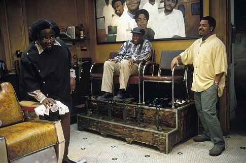 CEDRIC THE ENTERTAINER as Eddie, CARL WRIGHT as Checkers Fred, and ICE CUBE as Calvin hanging around the shop
