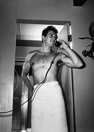 Rock Hudson with bare torso at his Hollywood Hills home, 1952. Modern silver gelatin, 14x11, signed. © 1978 Sid Avery MPTV