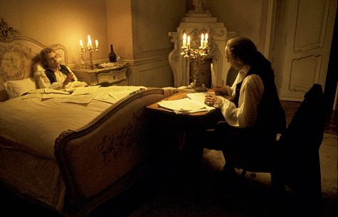 An ailing Mozart (TOM HULCE) dictates notes of music to Salieri (F. MURRAY ABRAHAM) who writes them down for him