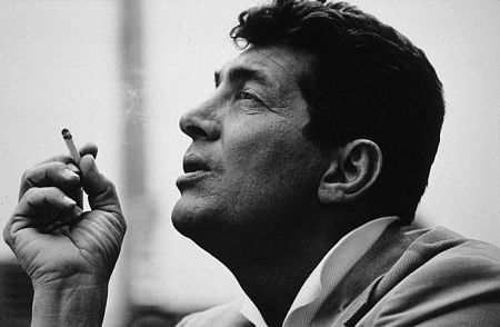 Dean Martin smoking a cigarette during a break from his television show in Hollywood, 1961. Modern silver gelatin, 11x14, signed. © 1978 Sid Avery MPTV