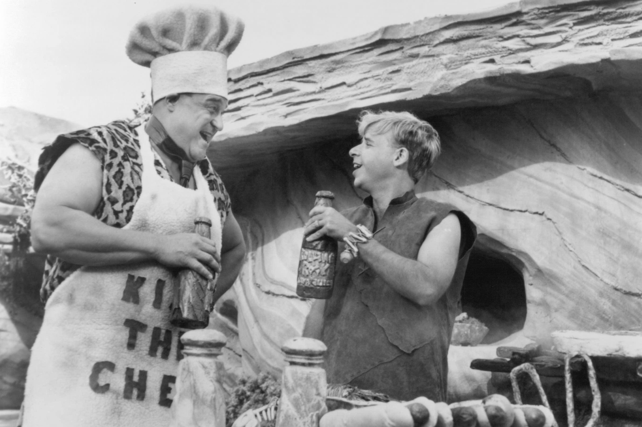 Still of John Goodman and Rick Moranis in The Flintstones (1994)