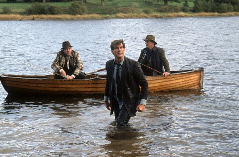 Desmond (PIERCE BROSNAN) jumps into the water to confront Michael (STEPHEN REA) and Nick (AIDAN QUINN).