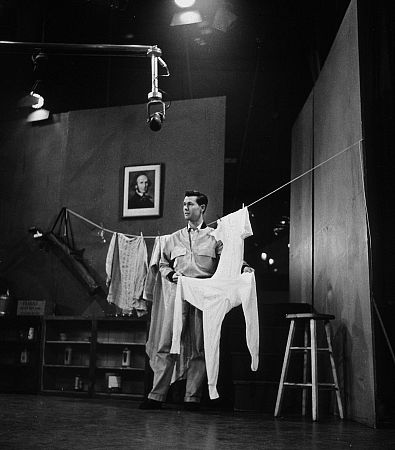 Johnny Carson hanging laundry on stage, 1953.