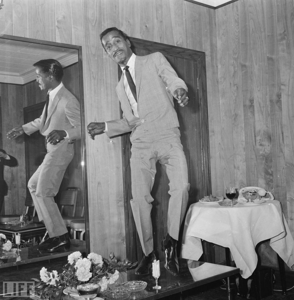 Sammy Davis Jr. tap dances on a table in his hotel room on May 3, 1966.